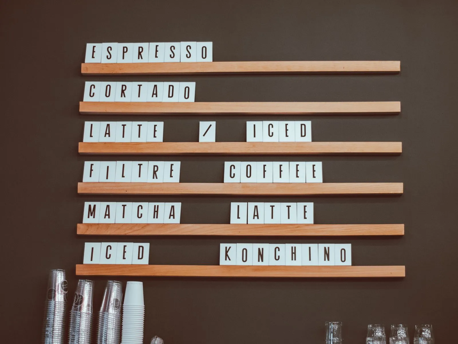 Stylish coffee shop menu board with coffee options like espresso and latte in a cafe setting.